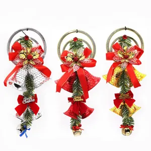 Festive set of three colorful Christmas bell ornaments with pine needles and red ribbons
