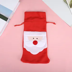 Detailed close-up of a festive red Santa Claus wine bottle gift bag with drawstring