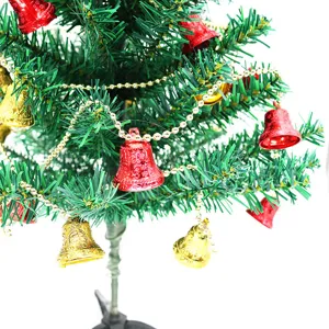 Detailed view of red and gold patterned bells on a festive garland for Christmas tree