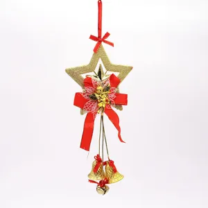 Detailed view of gold Christmas star ornament with angel, red bows and hanging bells