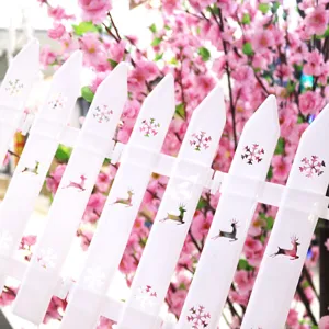 Detailed shot of white PVC Christmas fence featuring hollow reindeer and snowflake motifs