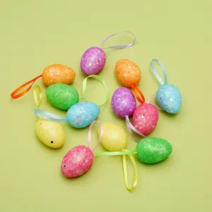Detail view of colorful glitter Easter eggs with ribbon hangers for DIY decorations.