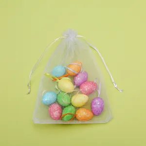 Glittery colorful Easter egg ornaments presented in a white mesh drawstring organza pouch