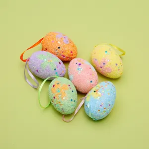 Detail shot of colorful foam Easter eggs with sequin glitter and hanging ribbon loops.