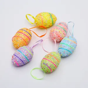 Detailed view of colorful foam Easter eggs with beaded texture and silk hanging ribbons