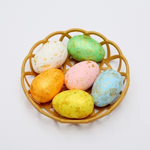 Close-up of vibrant speckled Easter eggs with gold foil details arranged in a brown basket