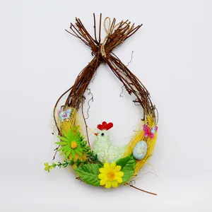 Detail shot of an Easter egg twig wreath with a chicken, colorful eggs and flowers.