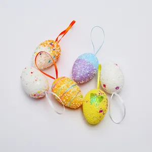 Set of colorful foam Easter eggs with beads and ribbons for hanging decoration.