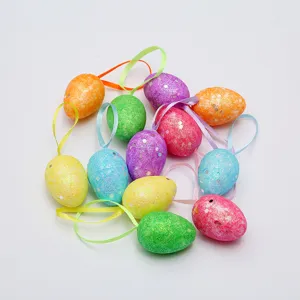 Close-up of glittery colorful DIY Easter egg ornaments with satin hanging ribbons