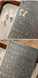 Close-up of TG-043 metal nail stamping plate with vintage badge and unicorn patterns