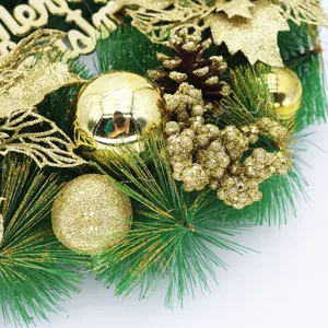 Close-up detail of a golden Christmas wreath with glitter balls and pine cones