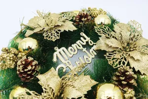 Close-up macro view of green Christmas wreath with gold glitter flowers and pinecone detail