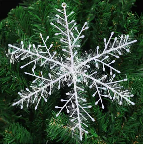 Vista de detalle macro de un adorno de copo de nieve blanco en un árbol de Navidad