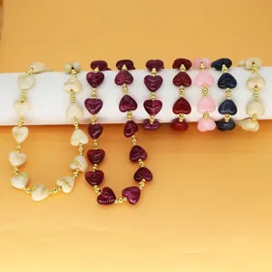 Detail of colorful resin heart beads with gold-tone spacers in multiple vibrant shades