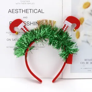 Detail shot of a festive green tinsel headband with upside-down elf legs and bells