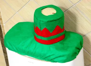 Detailed view of green elf hat toilet tank cover for Christmas bathroom decor.