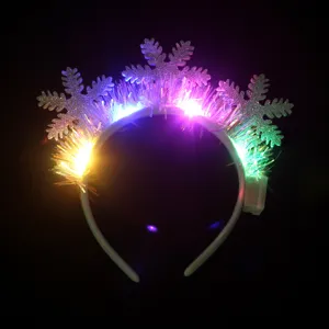 Glowing LED Christmas snowflake headband with colorful fiber optic lights on dark background.