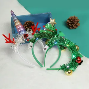 Detailed macro shot of LED Christmas headbands featuring reindeer antlers and trees