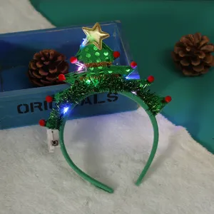 Detail of the illuminated green Christmas tree headband with LED lights and star