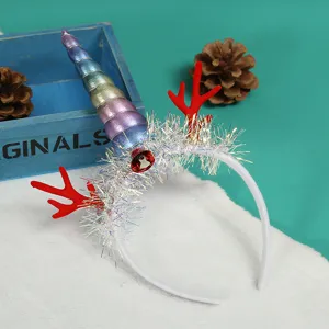 Detail showing rainbow unicorn horn and red reindeer antlers on Christmas headband