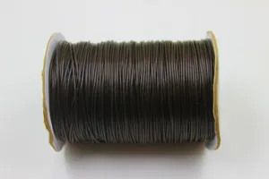 Close-up of a spool of dark brown waxed cord for DIY jewelry making and braiding