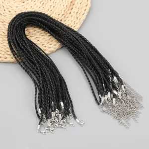 Detail of black braided necklace cords with silver lobster clasps and extension chains.