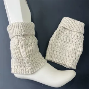 Detail shot of solid color ribbed knit wool leg warmers in cream white, soft texture.