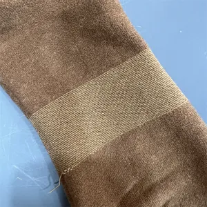 Close-up detail shot showing merino wool sock fabric texture and ribbed elastic band.