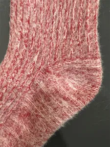 Close-up view of fuzzy merino wool blend sock showing soft knitted texture and heel detail.