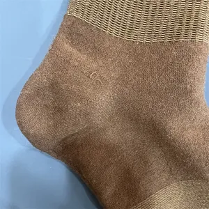 Close-up detail of brown merino wool hiking sock showing fine knit texture and heel.