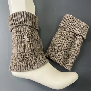 Detailed view of merino wool knit leg warmers featuring vertical stripes and cozy slouch design.