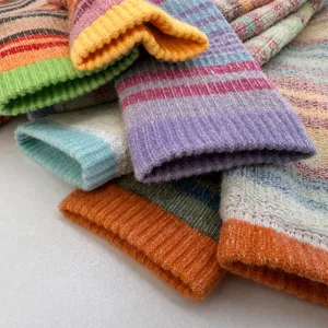 Close-up detail of thick thermal wool ski socks with colorful stripes, soft loop knit.