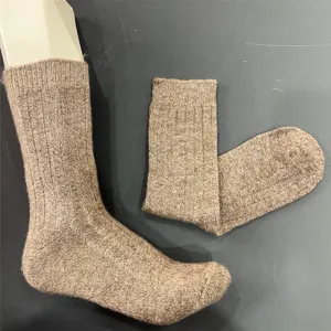 Detail view of brown merino wool mid-tube socks, ribbed cuff design for comfort and warmth.