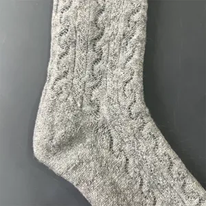 Grey merino wool knit sock detail, soft texture and warm winter design for outdoor hiking.