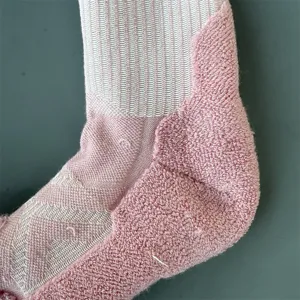 Close-up detail of knitted merino wool athletic sock heel, cushioned terry loop for hiking.