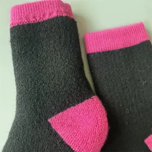 Close-up detail of women winter warm merino wool socks with pink contrast cuffs and heels.