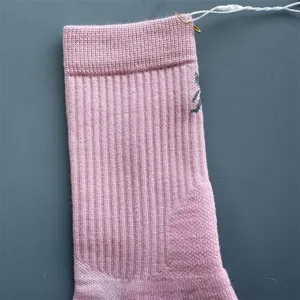 Merino wool mid-tube athletic sock detail view showing knit ribbed texture and pink color.