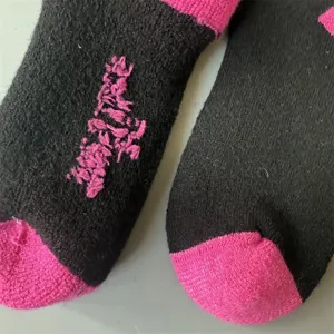 Merino wool thick thermal socks detail, black and pink color block winter cozy sports socks.