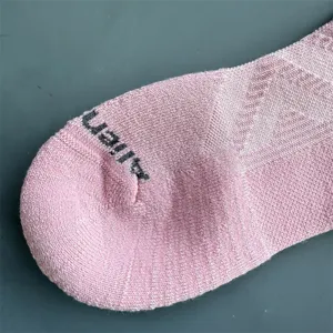 Merino wool athletic sock toe detail, pink half-cushion knit sports hiking sock close up.