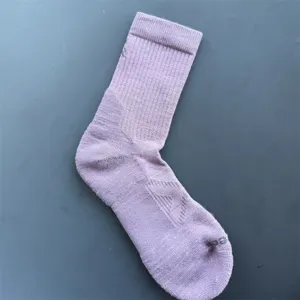 Merino wool sports sock detail view showing ribbed cuff and cushioned towel sole texture.