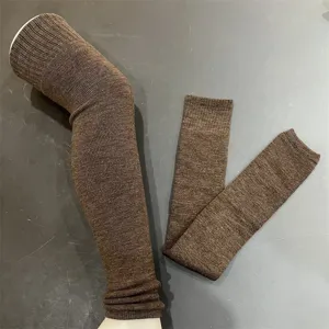 Detailed view of brown merino wool knit leg warmers, featuring thick cozy texture design.