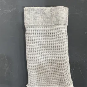 Close up view of grey merino wool sock detail featuring breathable knit pattern and ribbed cuff.