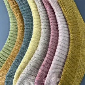 Close-up of merino wool ribbed socks in vibrant candy colors, showing soft knit texture.