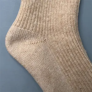 Close-up detail of merino wool knit sock showing heel structure and fine texture.