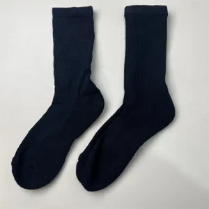 Close-up detail of thick ribbed crew socks, soft texture and solid dark color design.