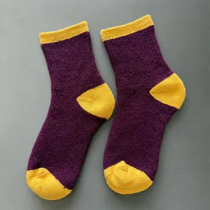 Merino wool thick thermal socks detailed view showing purple and yellow design.