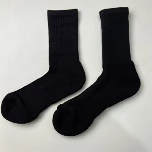 Thickened black merino wool hiking crew socks with seamless half-towel sole for outdoor sports.
