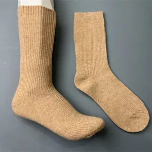 Detailed view of solid color ribbed knit wool blend mid-tube socks in versatile camel color.