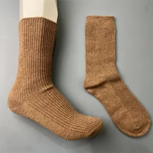 Details of the brown merino wool ribbed mid-tube socks showing fine knit texture and elasticity.
