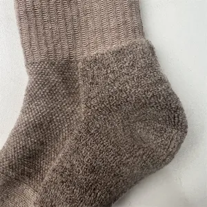 Close-up detail of thickened merino wool half-towel men thermal hiking athletic socks texture.